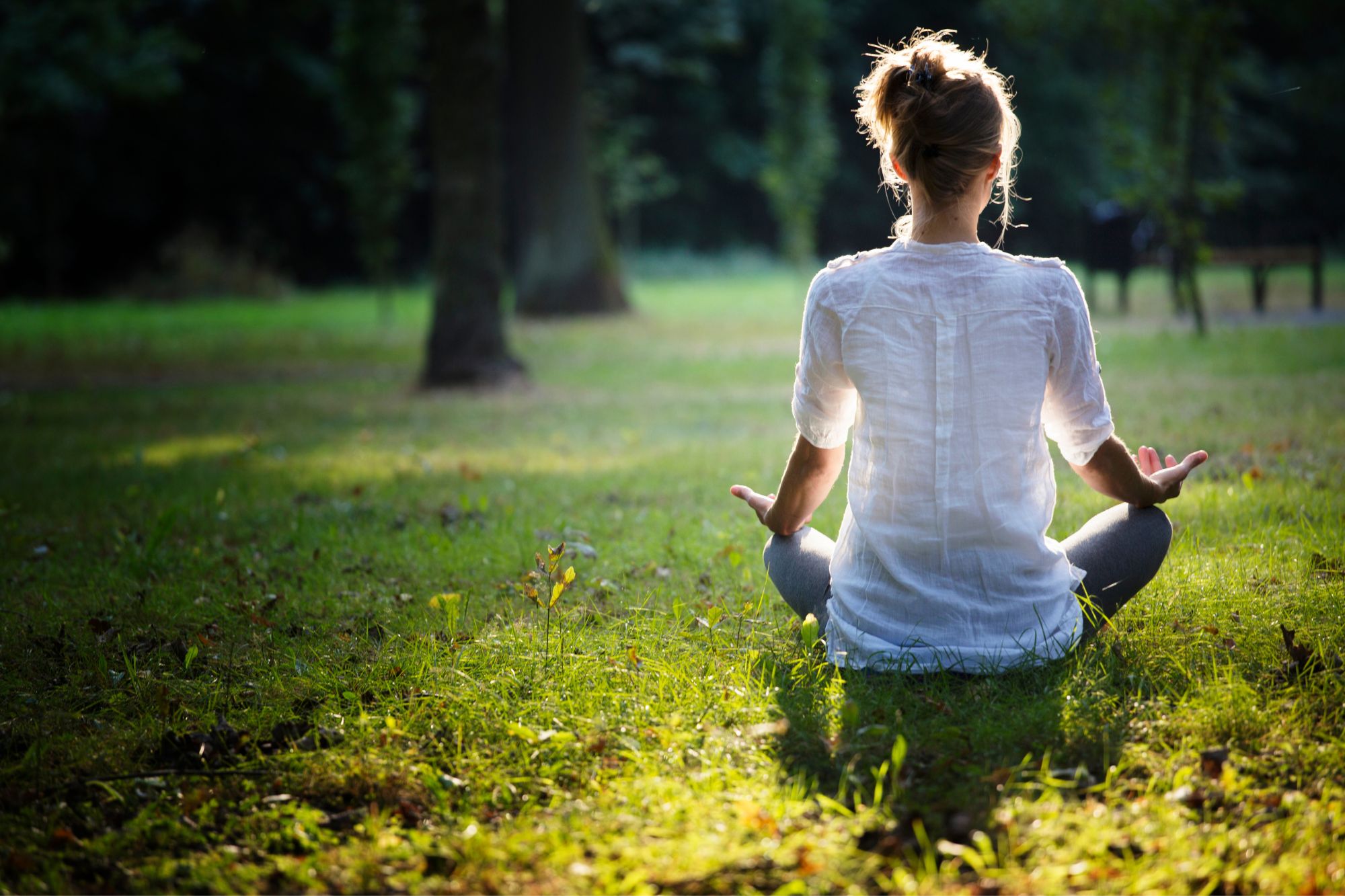 Woman meditating in forest